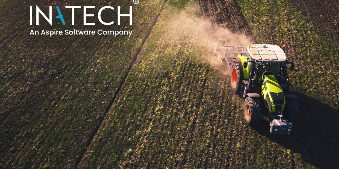 A tractor harvesting field crops