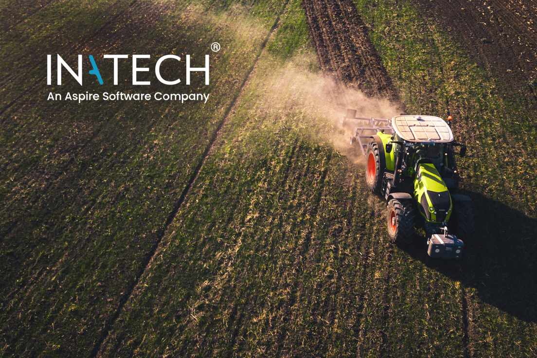 A tractor harvesting field crops